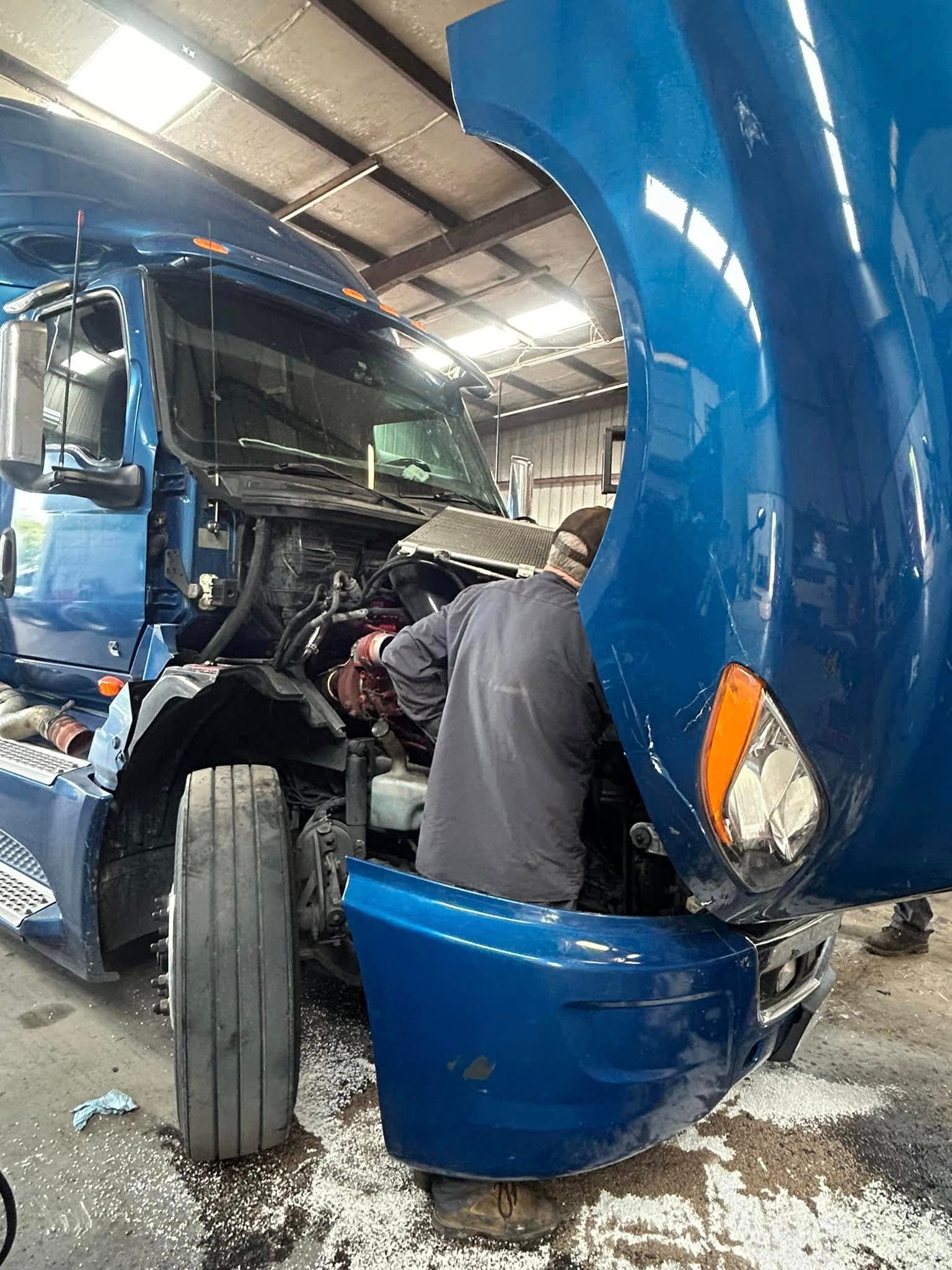 Port City Repair technician servicing a fleet truck engine